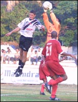 Vasco striker Rio Wanderlei's header is collected by Mahindra 'keeper Virender Singh