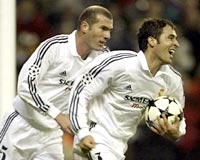 Real's Raul Gonzalez (R) celebrates with team mate Zinedine Zidane after scoring.